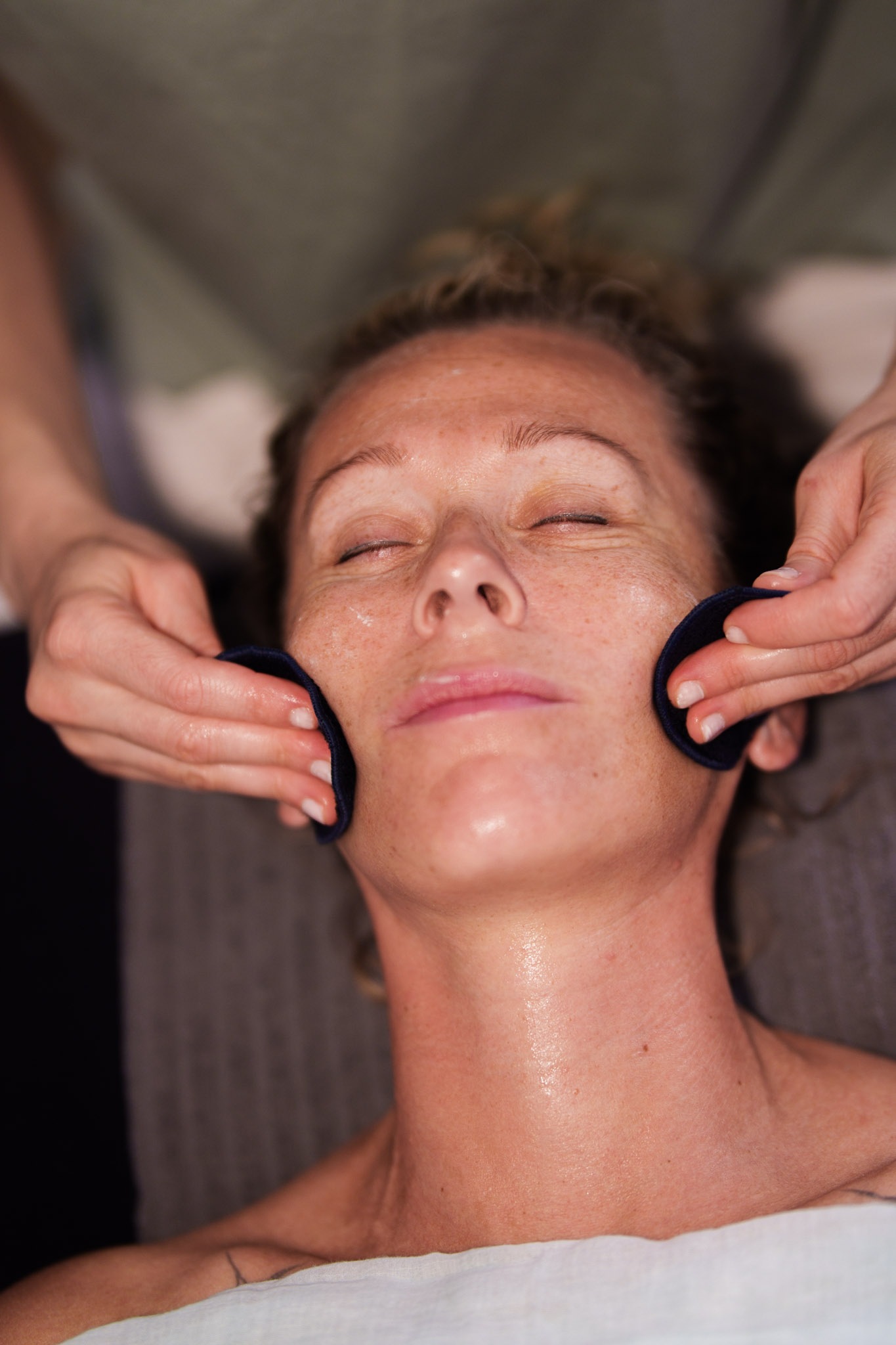 Facial. Using pads to wipe off the cleanser. 
